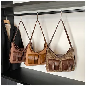 Three multi-pocket hobo bags in coffee, khaki and plaid textures on hangers