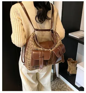 Detail of tweed and leather patchwork backpack showing multi-pocket design on model