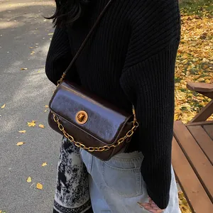 Women's chocolate leather square shoulder bag with gold chain and rotary buckle