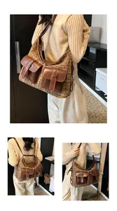 Detail shot of large tweed hobo bag with multi-pockets shown on model in home setting
