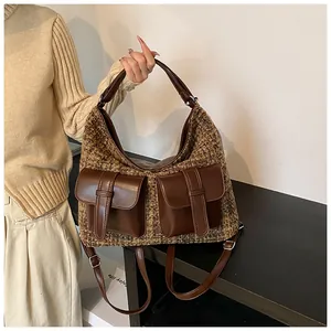Detail of tweed multi-pocket backpack showing brown texture and versatile straps