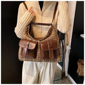 Detail of winter tweed hobo bag with leather pockets and adjustable shoulder strap