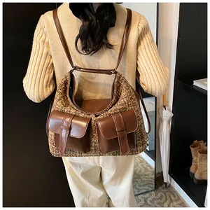 Detail of tweed and leather multi-pocket backpack showing strap texture and warm winter style