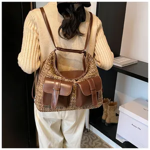 Detail of vintage brown tweed and leather backpack worn by model for daily commute