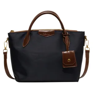 Large capacity navy oxford cloth tote bag with brown leather handles and adjustable strap
