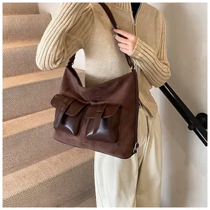 Detail of vintage brown textured tote bag with double front flap pockets and buckles