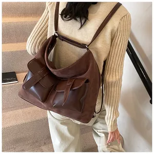Detail of vintage brown large capacity multi-pocket backpack with matte suede texture