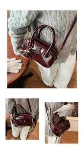 Detail of burgundy glossy pillow bag with metal chain strap and Christmas star charm