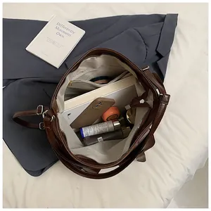 Top view of the interior compartment of a brown tote bag showing multi-pocket storage space