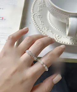 Detail shot of elegant S925 silver lace rings with pearls and intricate floral patterns