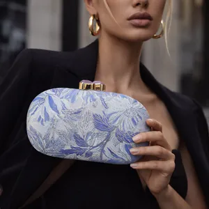 Elegant floral jacquard evening clutch bag with gold metal clasp and gemstone details