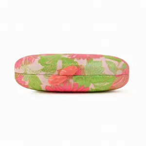 Detailed view of floral embroidery clutch bag with unique coral lip-shaped clasp