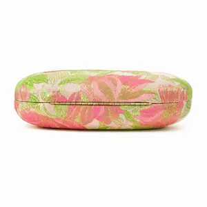 Detail view of pink and green floral brocade evening bag with golden metal hinges
