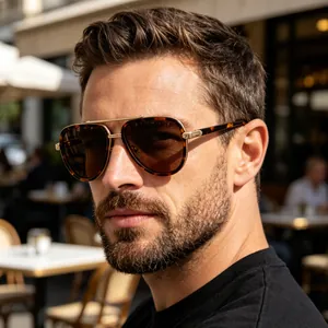 Close-up of tortoise shell aviator sunglasses with gold metal bridge and brown lenses