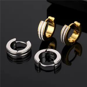 Detail of gold and silver hoop earrings with brushed metal texture and snap closure