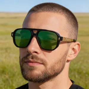 Close-up of vintage pilot sunglasses with green lenses and detailed gold temple accents