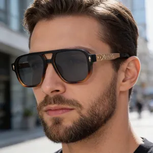 Detail view of gold metal temples with embossed geometric patterns on square sunglasses