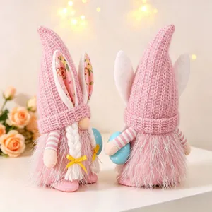 Pair of handmade pink Easter gnome couple dolls with bunny ears holding blue eggs