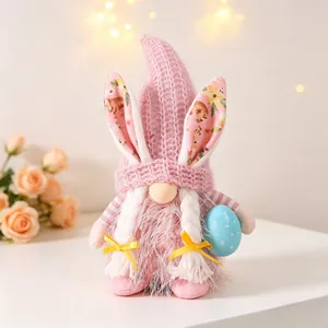 Handcrafted pink Easter gnome plush holding blue egg with floral rabbit ears and braids
