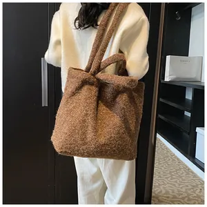Dettaglio della borsa tote in peluche marrone scuro con etichetta in pelle our fave