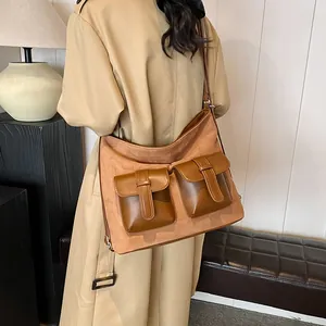 Brown suede hobo bag with multiple pockets and vintage buckles for daily use