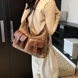 Brown tweed and leather multi-pocket crossbody bag shown in a stylish indoor setting