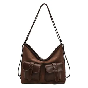 Large dark brown suede tote bag with dual front pockets and adjustable shoulder strap
