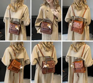 Brown vintage PU leather bag with white stitching and bear charm shown on model