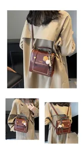 Detail of vintage brown leather handbag with pearl trim and sporty baseball charms