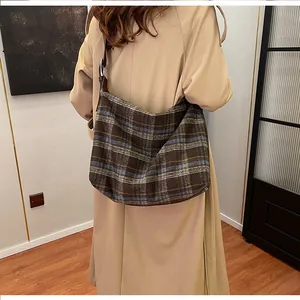 Gros plan du sac hobo vintage aux motifs tissés à carreaux marron et bleu élégants