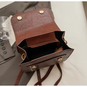 Interior detail of vintage brown leather bag showing magnetic closure and compartments