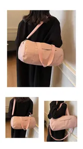 Pink cylinder yoga bag with adjustable strap and side pocket detail for fitness
