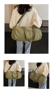 Detail view of olive green yoga cylinder bag showing wide straps and nylon fabric texture