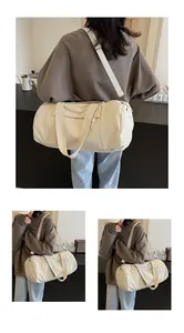 Detail of off-white cylindrical yoga bag showing dual straps and minimalist canvas design