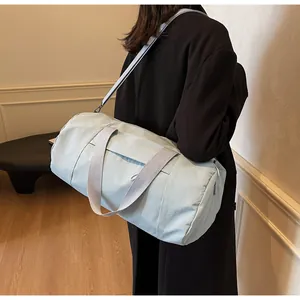 Detail of light blue cylinder sports bag with grey adjustable straps for yoga and fitness