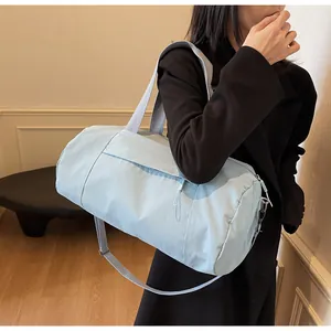 Detail of light blue waterproof nylon duffel bag with gray straps for yoga and fitness
