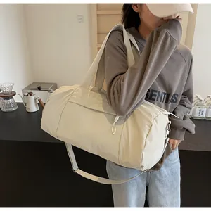 Large capacity yoga gym bag in beige nylon fabric shown in lifestyle setting