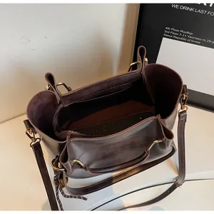 Top view of deep brown tote bag interior featuring gold hardware and inner zipper pocket