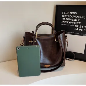 Macro view of dark brown tote bag capacity with a tablet inside to show interior size