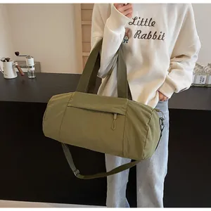 Close-up of olive green yoga bag showing water-resistant nylon texture and zipper pocket