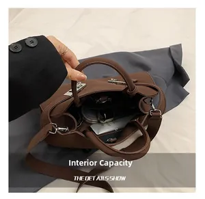 Internal capacity of brown leather tote bag showing personal care items like powder compact