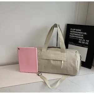 Detailed capacity view of beige cylinder yoga bag with pink tablet as size reference