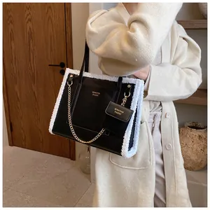 Detail of black PU leather tote with white faux fur trim and matching mini coin purse