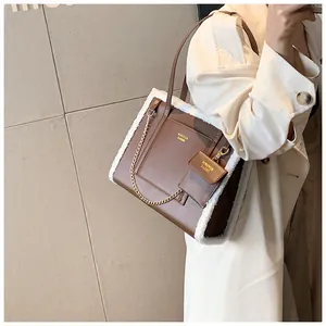 Detail of a brown leather tote bag with white plush trim and a matching coin purse charm