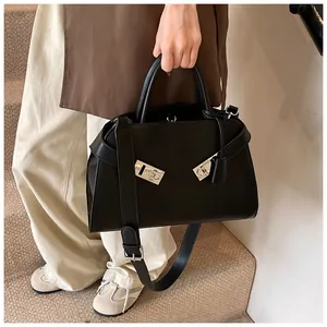 Detail of elegant black tote bag featuring distinctive silver twin metal Gancini clasps