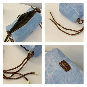 Detail view of light blue denim texture bag with braided strap and inner pocket