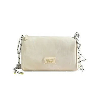 Minimalist beige textured chain underarm bag with striped fabric and rope strap
