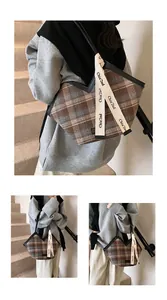 Detail of vintage plaid tote bag featuring Chia'2nd lettered straps and textured fabric