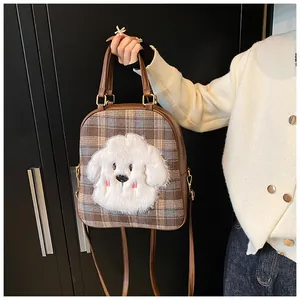 Detailed view of the brown plaid tote bag featuring a 3D plush dog charm decoration