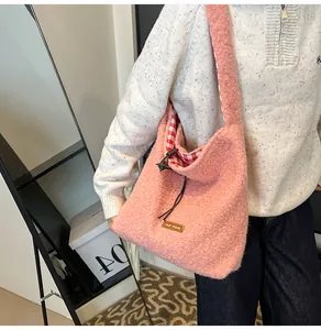 Detail of pink faux fur bucket bag featuring gingham lining and brown drawstring closure